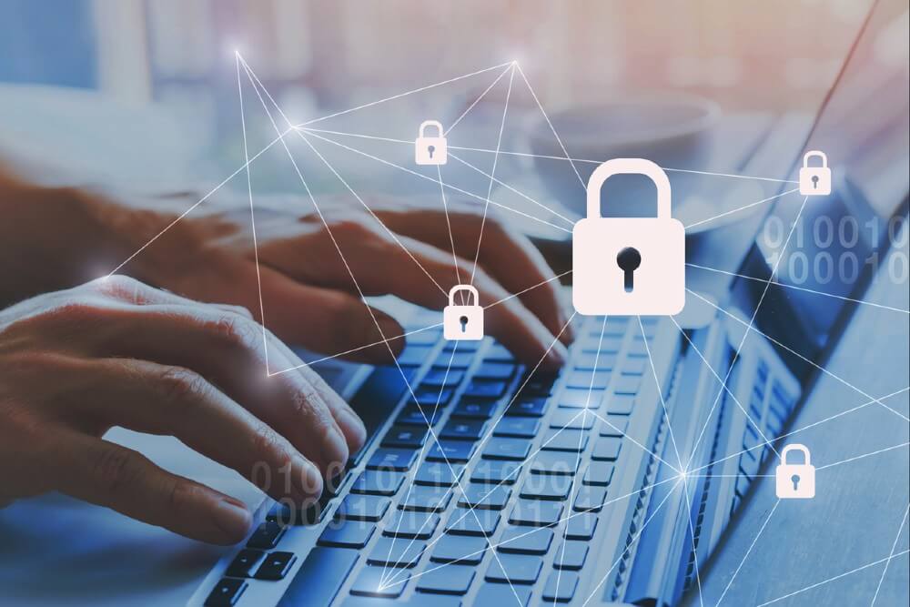 Hands typing on a laptop keyboard with floating padlock icons over the screen
