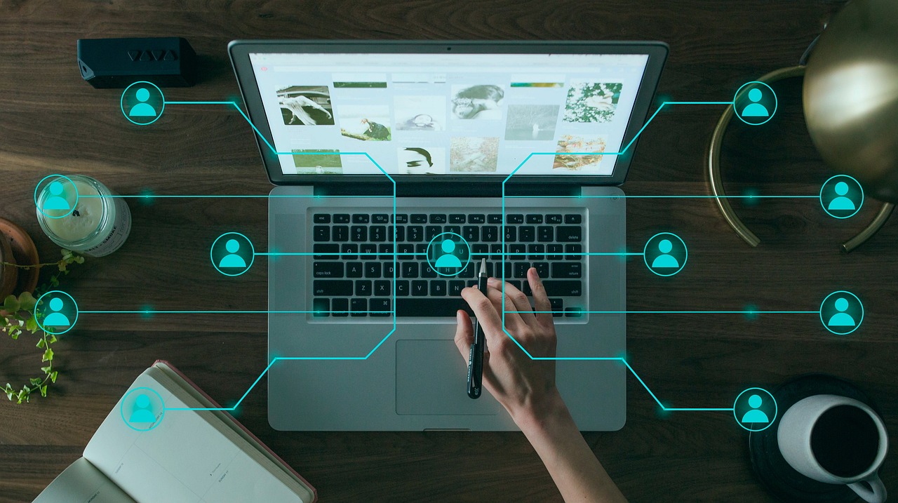 Person using a laptop with connected network icons
