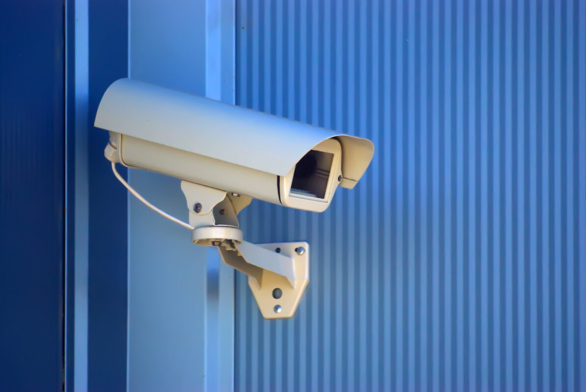 surveillance camera security on a blue wall utc