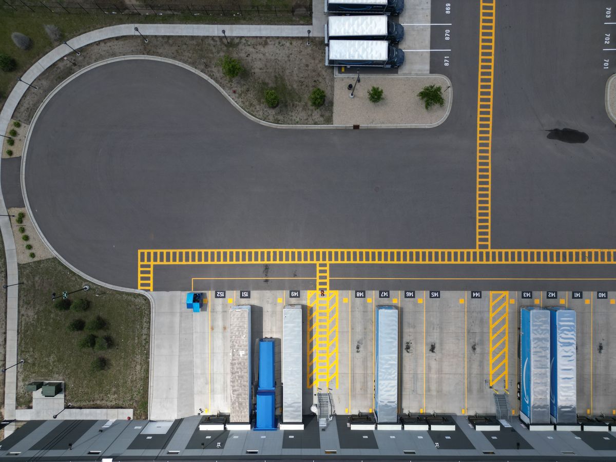 Overhead view of trucks parked at an industrial loading dock