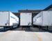 Trucks parked at loading docks of a logistics warehouse