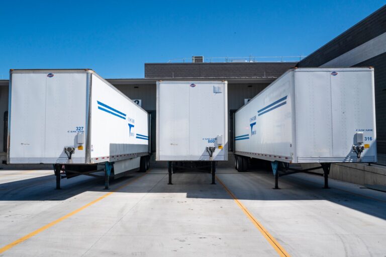 Trucks parked at loading docks of a logistics warehouse