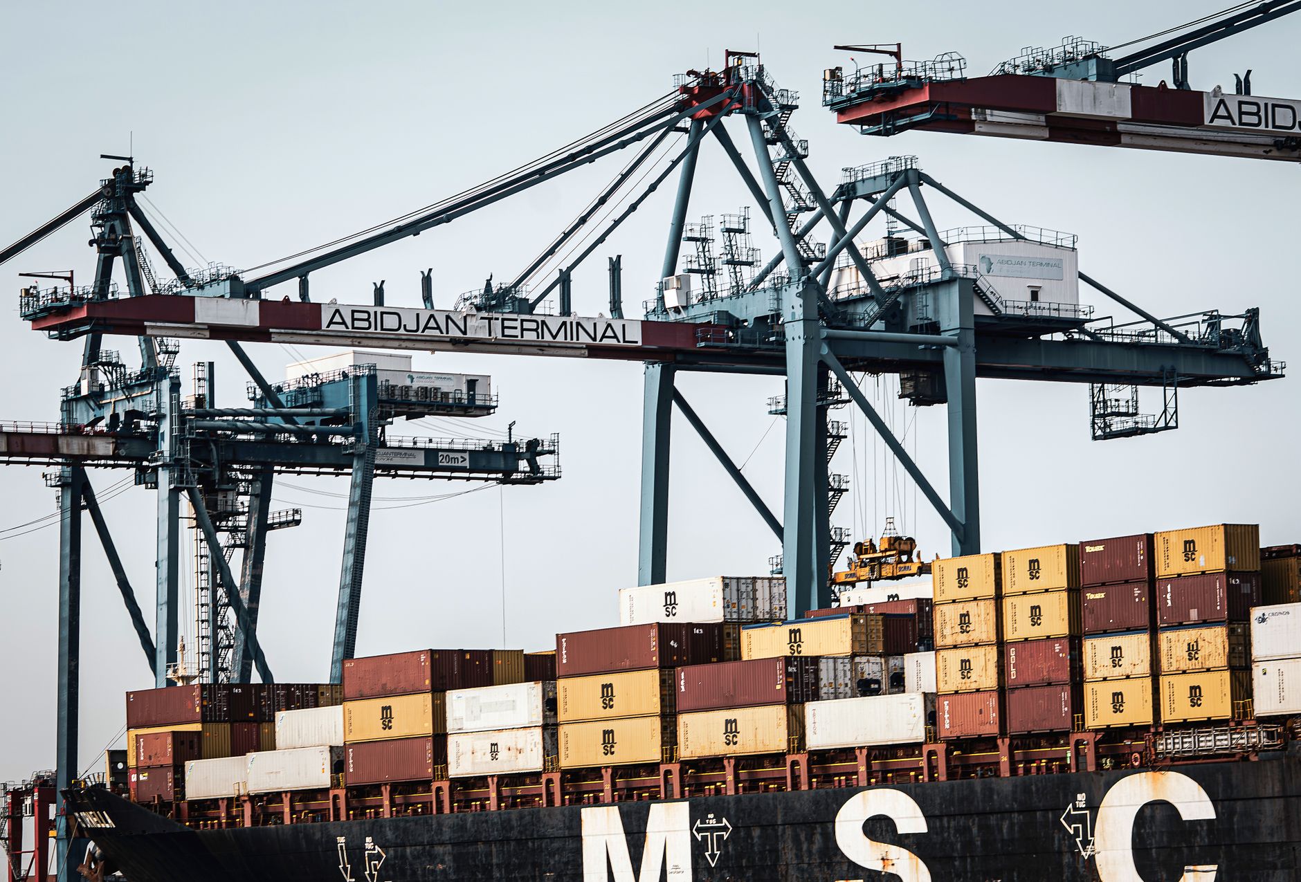 Quay cranes loading containers onto a ship at an automated container terminal