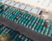Inland container depot with stacked containers, a reach stacker and a container train