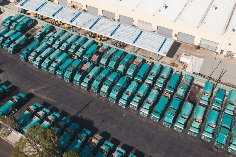 Inland container depot with stacked containers, a reach stacker and a container train