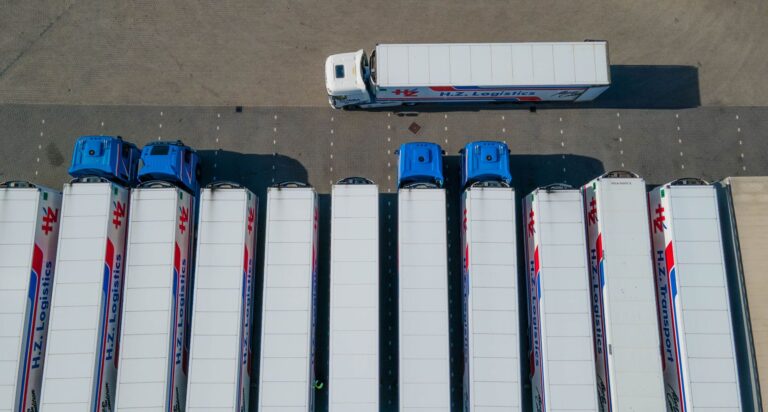 Truck driver using an intelligent terminal for weighbridges beside a weighbridge platform