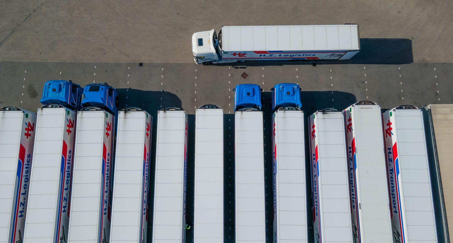 Truck driver using an intelligent terminal for weighbridges beside a weighbridge platform