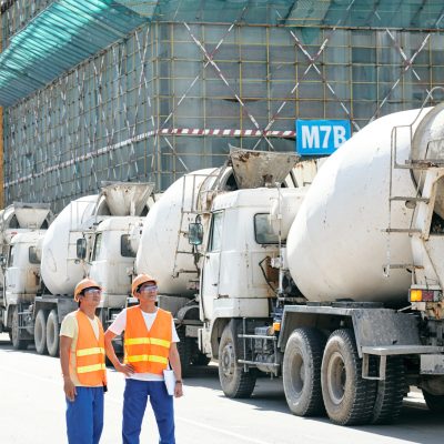construction workers inspecting concrete trucks at utc